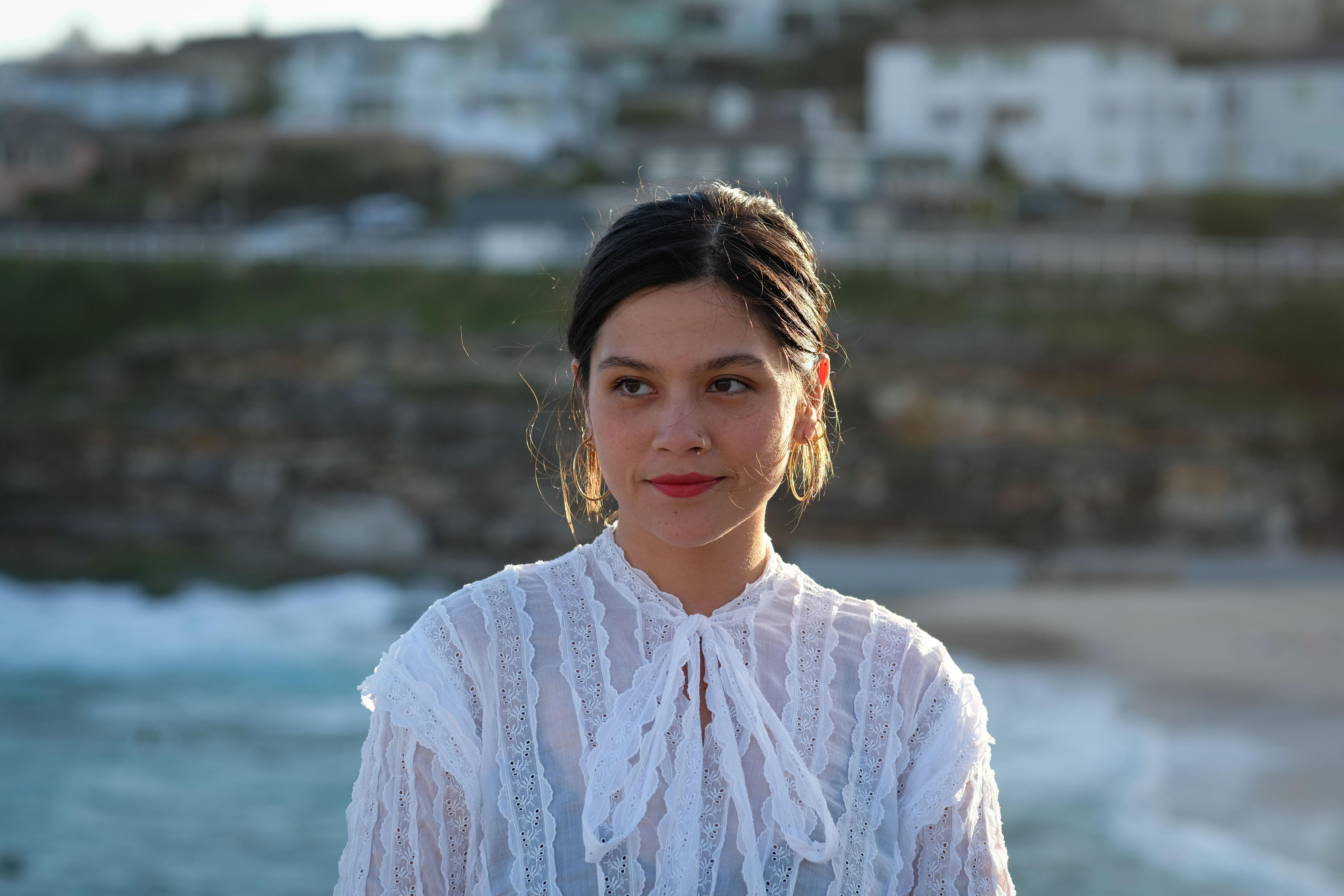 Woman wearing a white blouse and red lipstick 