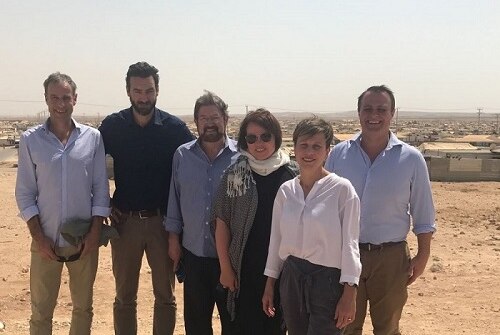 Six Australian parliamentarians including Derryn Hinch, Jenny McAllister and Tim Wilson stand in Zaatari refugee camp.