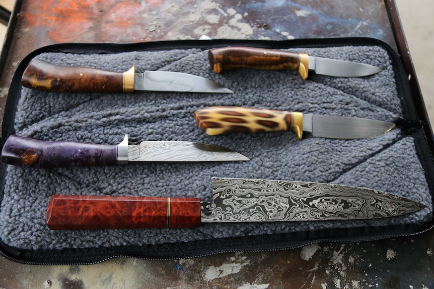 Knives laid out on a table.