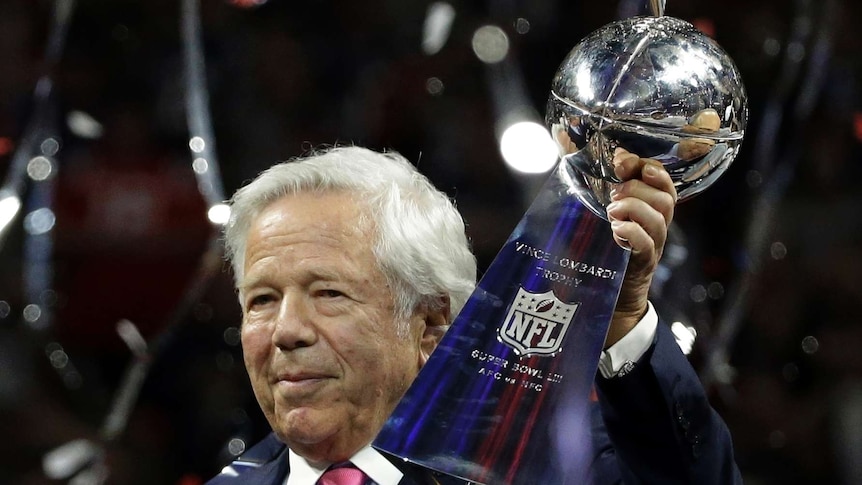 Robert Kraft holds up the Vince Lombardi trophy