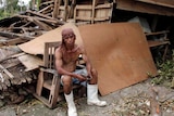 A man rests after Typhoon Haiyan hit Tabogon town in central Philippines.