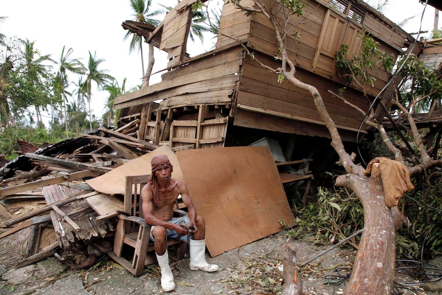 A man rests after Typhoon Haiyan hit Tabogon town in central Philippines.