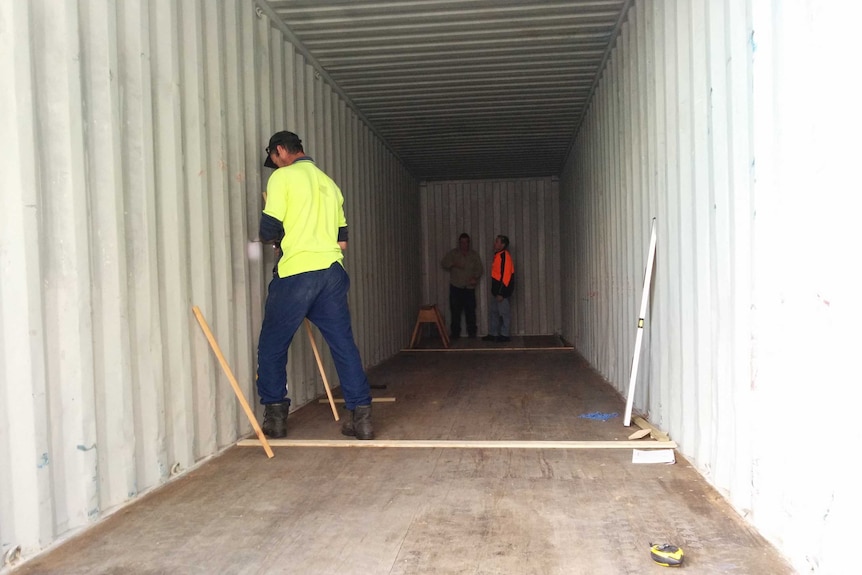 A shipping container being converted into a tiny house.