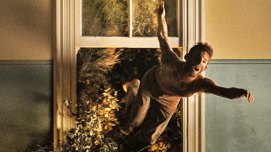 A promotional image of a male dancer dancing in front of open window