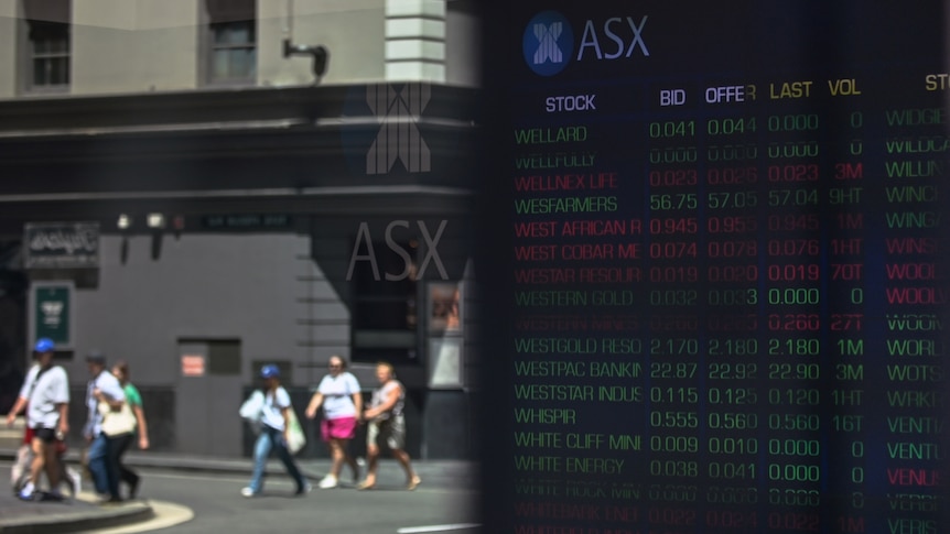 Four people walk along a footpath in front of the ASX building on a sunny day.