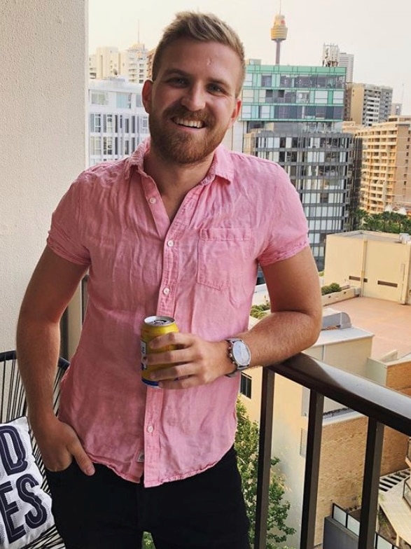 Eliot Hastie smiling on a balcony