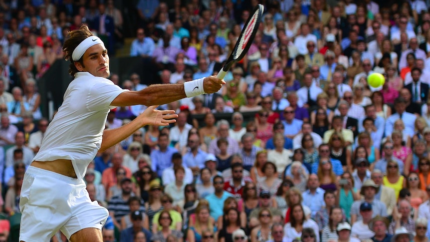 Roger Federer hits a return to Canada's Milos Raonic at Wimbledon on July 4, 2014.
