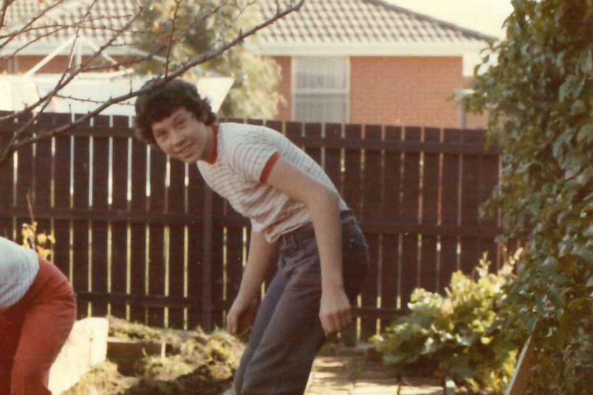 A photo of a young Brendan Sokaluk leaning over wearing long pants and a shirt