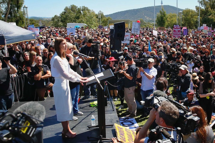 Brittany Higgins speaks in front of a large crowd.