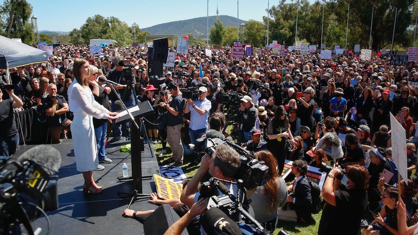 Brittany Higgins speaks in front of a large crowd.