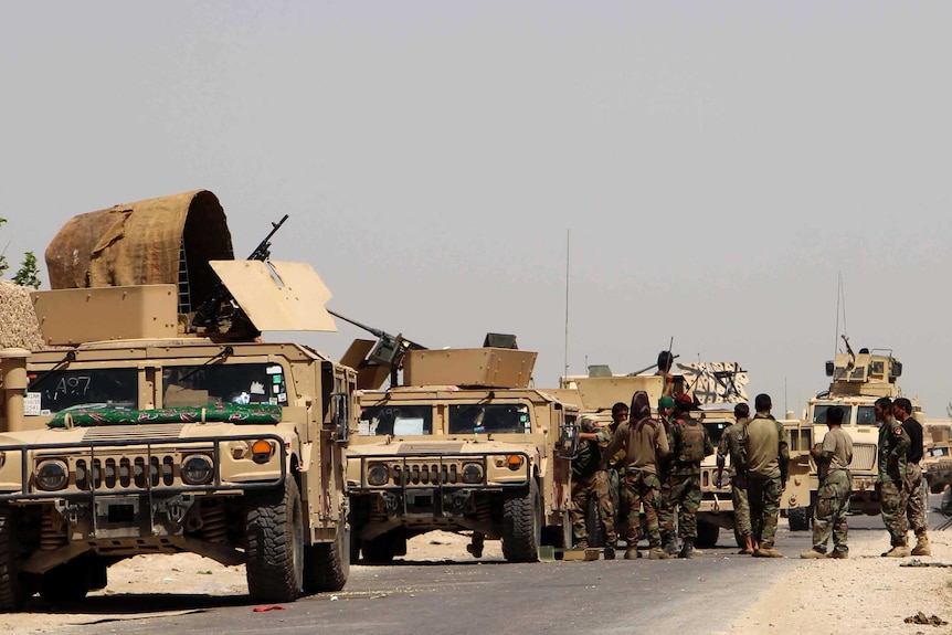 Military convoy in parked by the side of the road in Afghanistan, 2016.