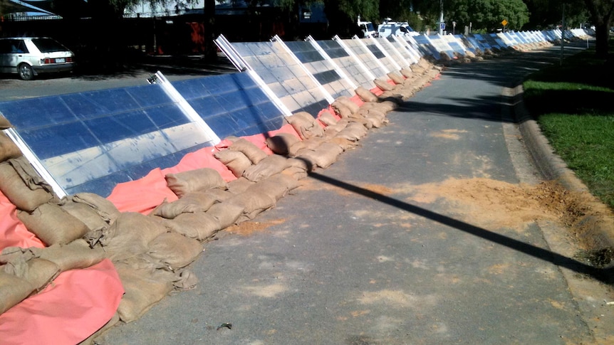 Sandbags and plastic cover the levee at Nathalia.