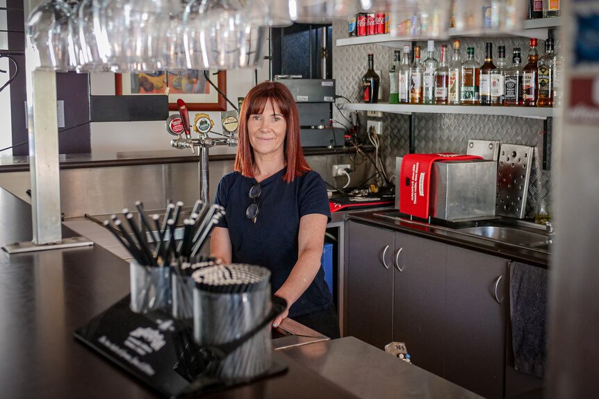 Jill stands behind the bar of the Wheatsheaf hotel in Terang