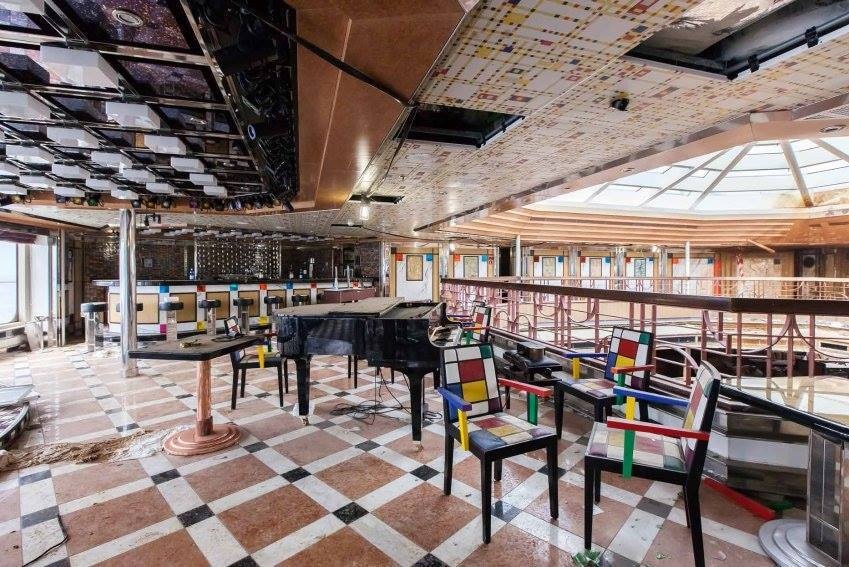 Water-damaged piano bar area, with debris strewn everywhere.