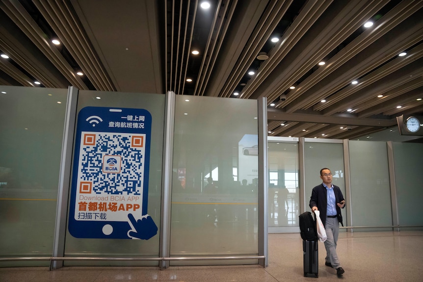 A traveller walks through the international flight arrivals area at Beijing Capital International Airport.