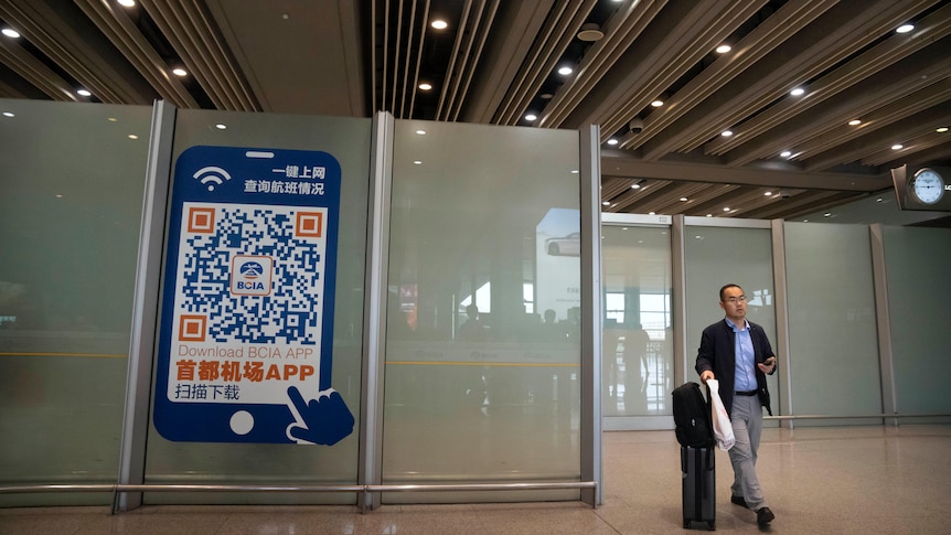 A traveller walks through the international flight arrivals area at Beijing Capital International Airport.