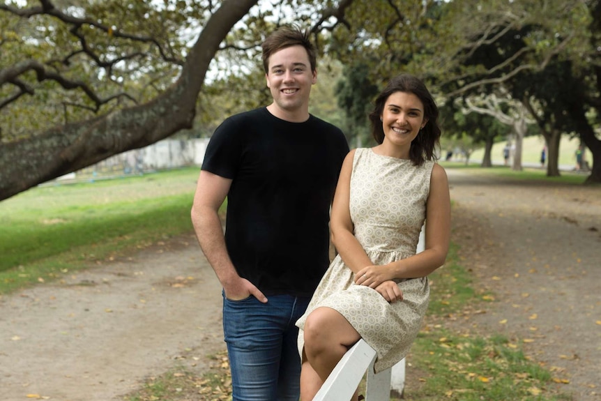 A young man and a woman in a park.