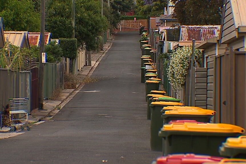 A street lined with rubbish bins