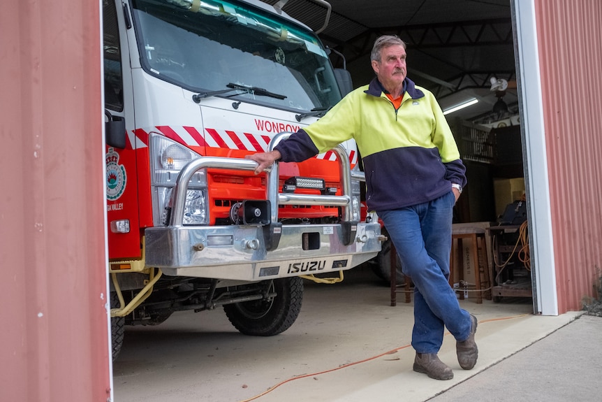 A man in RFS uniform stands in front of a fire truck