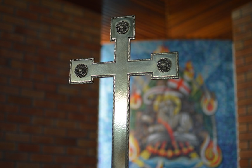 A close-up of a metal cross in a church