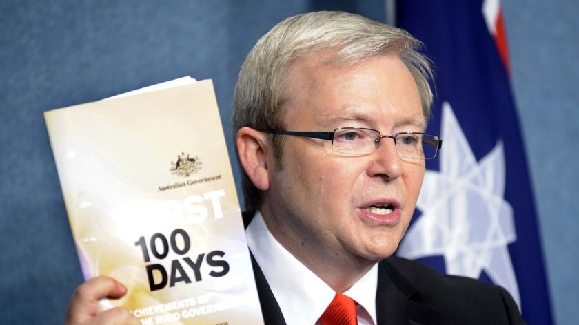 Kevin Rudd holds up his 'First 100 Days' booklet