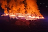 A night view of a spreading patch of burning lava.