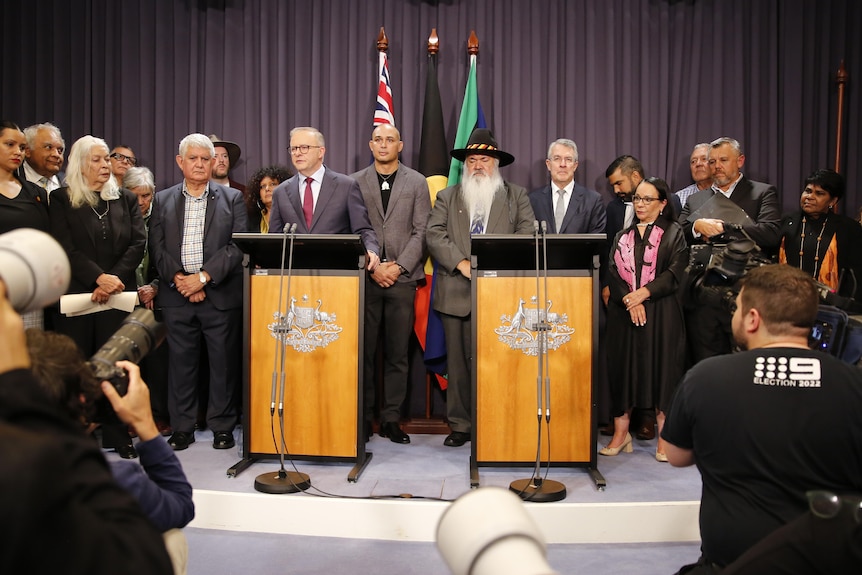 Anthony Albanese and Referendum Working Group members stand behind lecterns to announce the proposed Voice to Parliament wording