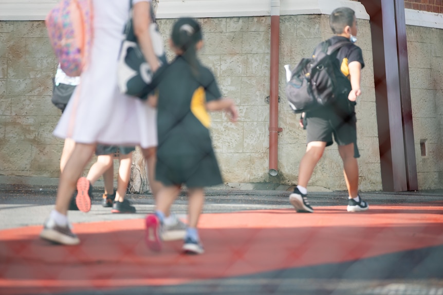 School children walking to their class in school.