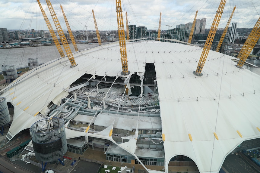 The white-domed roof of the O2 arena is seen damaged by the wind.