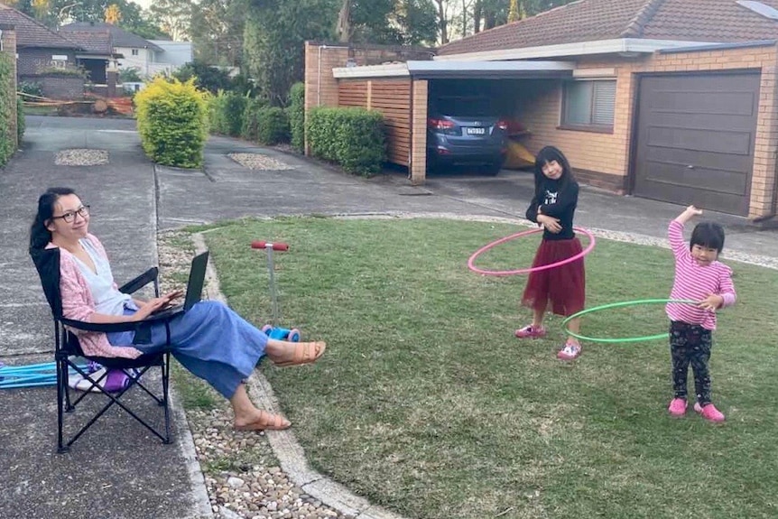 A mother and two daughters at their backyard during isolation.