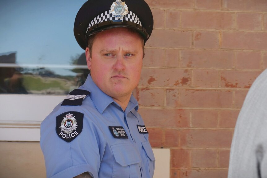 A close-of Brent Wyndham in police uniform.