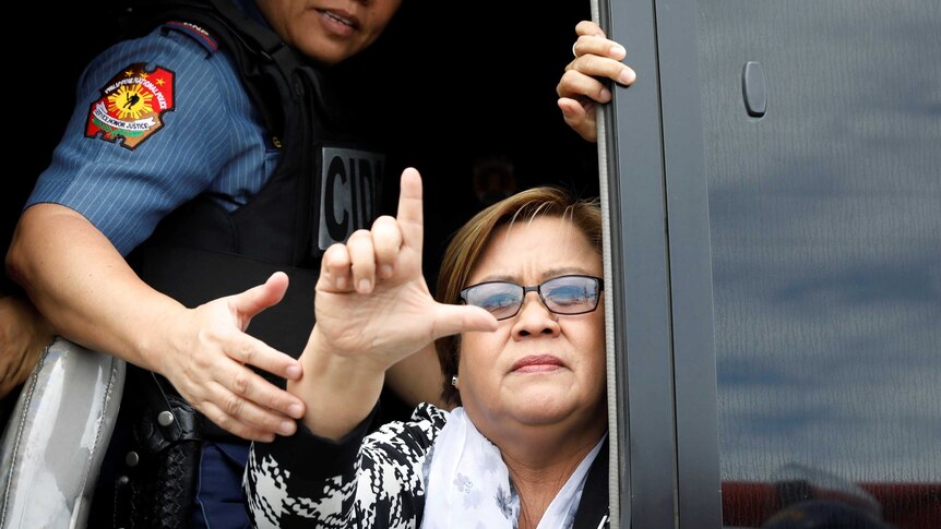 Philippine Senator Leila De Lima gestures a sign that means "fight".