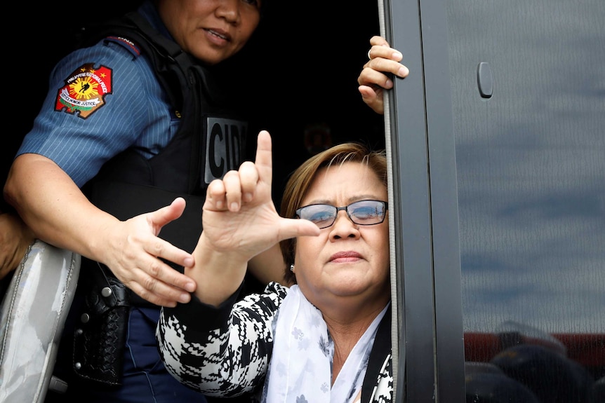 Philippine Senator Leila De Lima gestures a sign that means "fight".