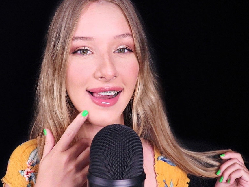 A young woman with a microphone.