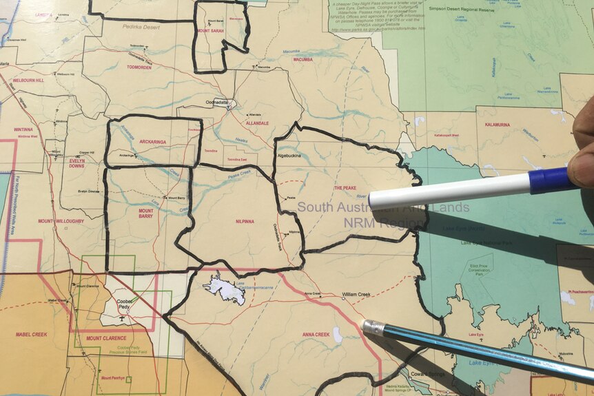 Pens pointing to a map showing the properties the Williams family will buy