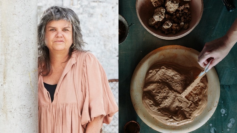 An Indigenous woman with grey hair and a pale pink top looks at the camera. A hand stirs a bowl of wet clay.