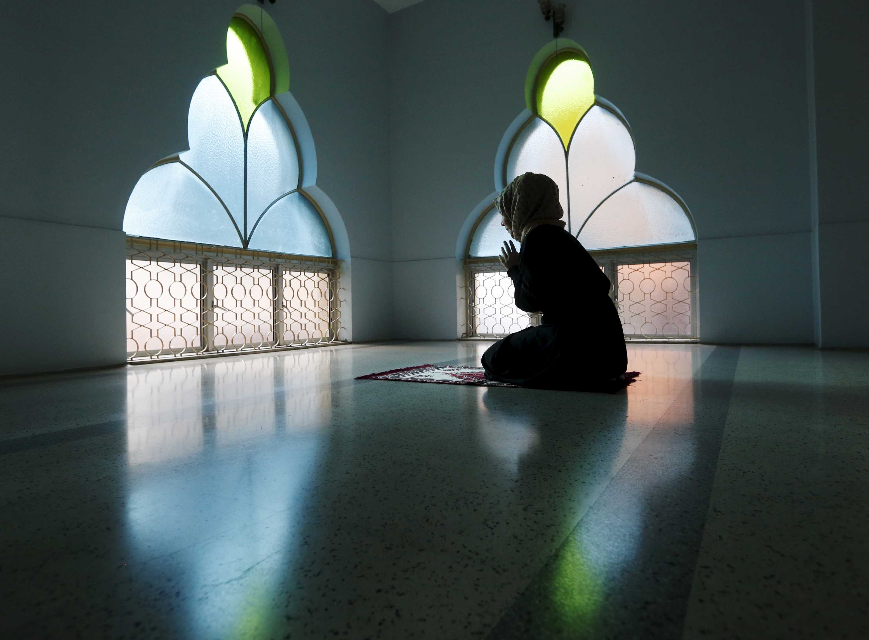 A woman prays at a mosque on the first day of Ramadan