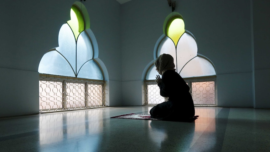 A woman prays at a mosque on the first day of Ramadan.