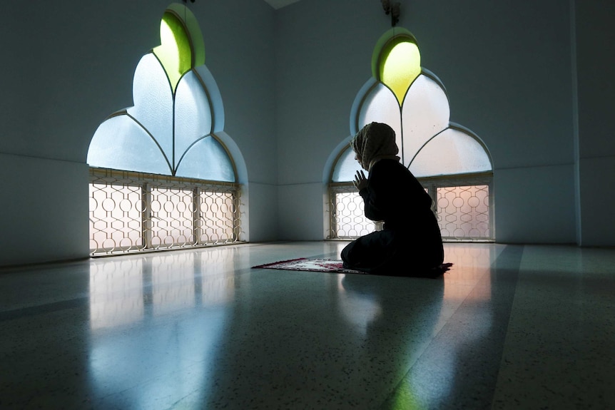 A woman prays at a mosque on the first day of Ramadan