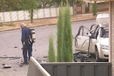 investigators at car explosion