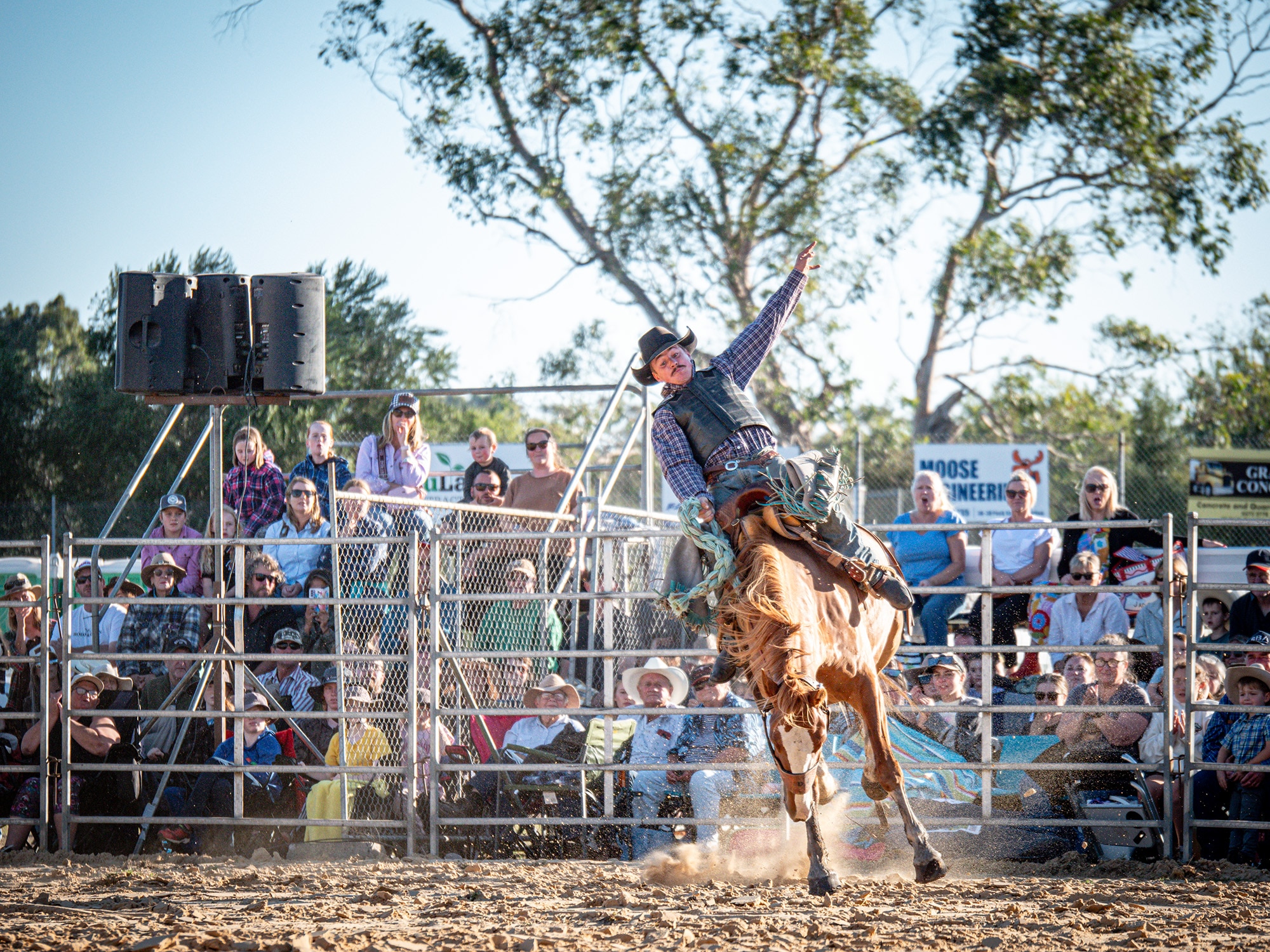 A man on horseback puts his arm out.