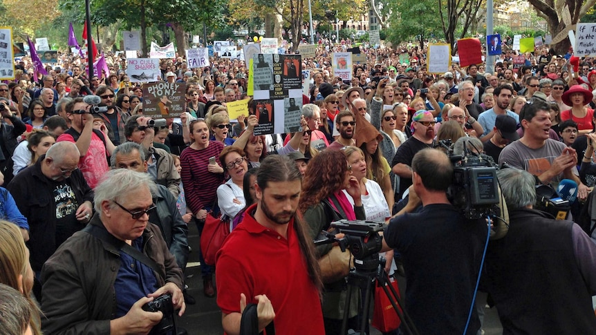 Demonstrators gather in Sydney at a rally to protest against the Abbott Government's budget cuts on May 18, 2014.