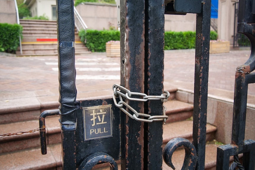 A wrought iron gate locked together with a chain 