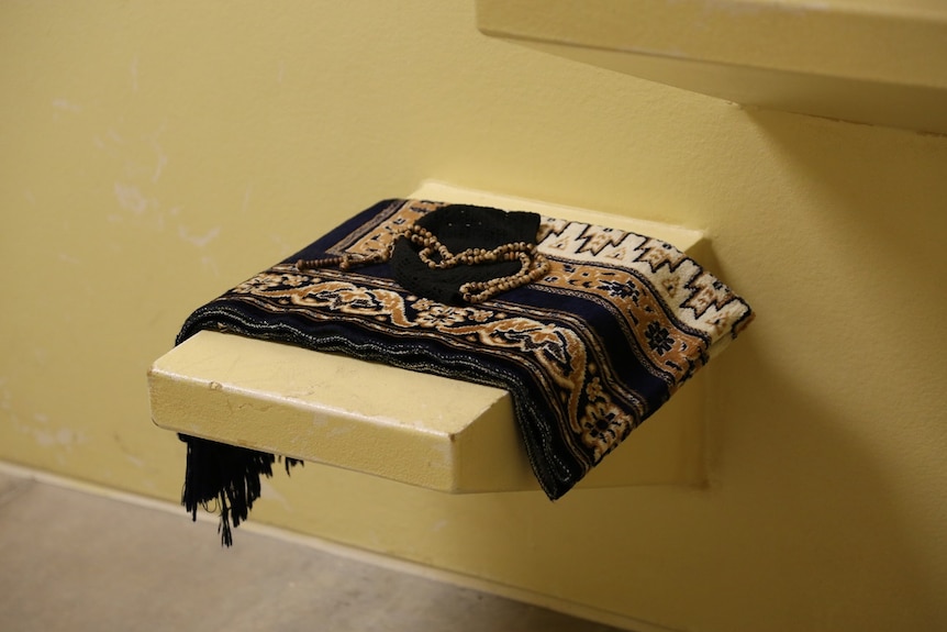 Prayer beads and a patterned cloth on a small bench