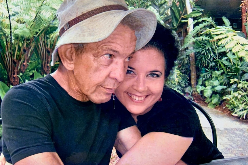 Colour photograph of Owsley Stanley embracing his daughter, Redbird