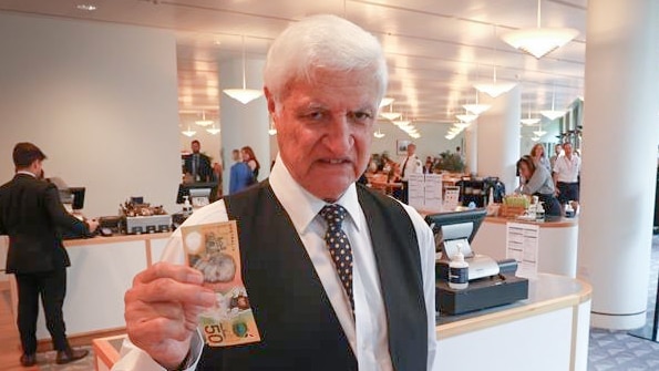 A man with a $50 note