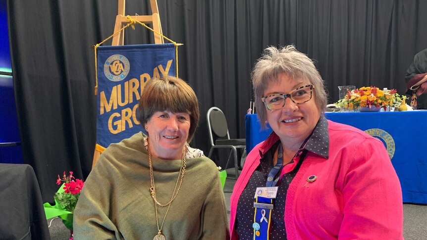 Two members of the Country Women's Association smiling for the camera at a conference in Albury NSW.