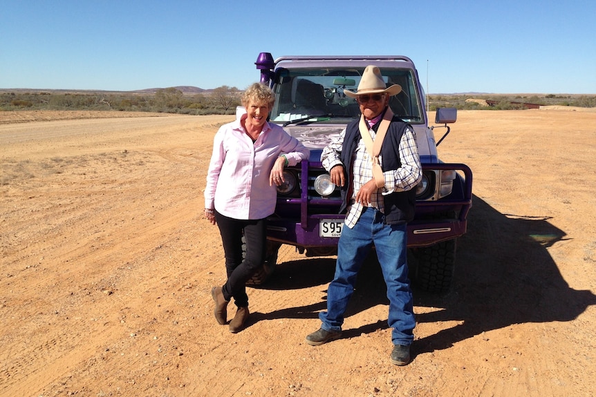 Heather Ewart with Bobby Hunter leans against the bullbar of a four-wheel drive.