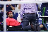 Jo-Wilfried Tsonga receives attention for a leg injury at the US Open