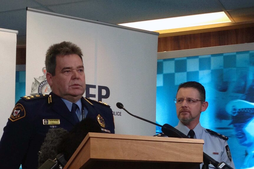 Tasmania Police's Mark Mewis and AFP's Nigel Ryan at a media conference